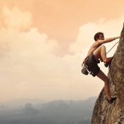 athletic man climbing a mountain
