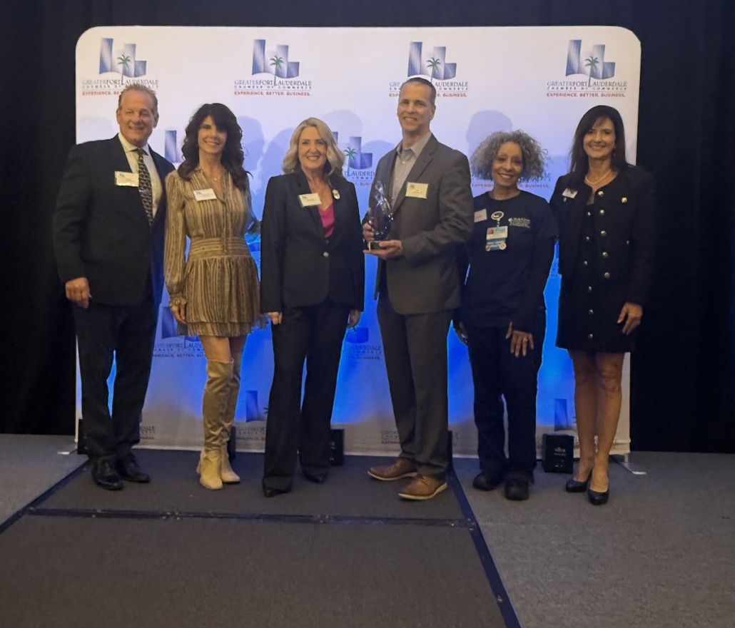 Dr. Leone had surgery that day, so he was represented by the Director of Orthopedics at Holy Cross Health, his secretary, Lola and wife DeeAnn Leone accompanied by members of the Better Business Bureau 