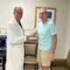 Bennett Quade shaking hands with Dr. Leone Total Knee patient