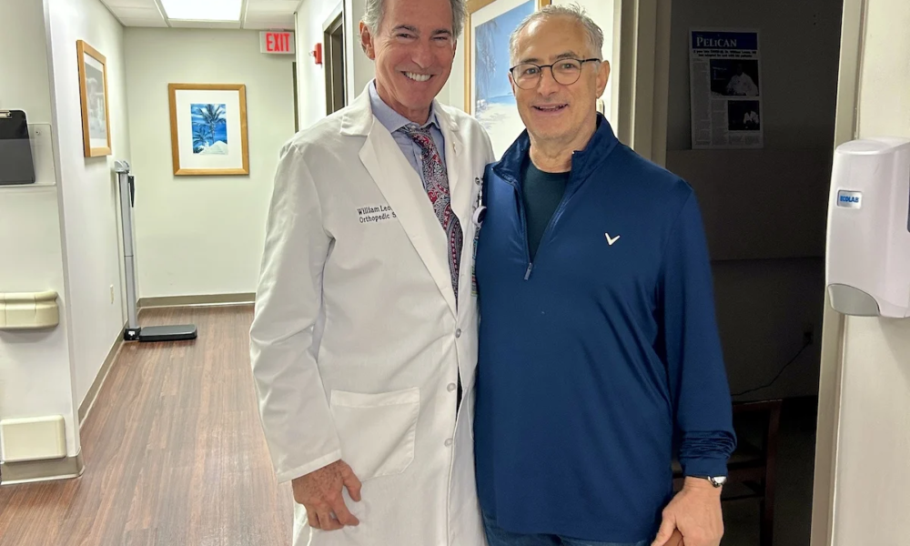 Andrew is taking a picture with Dr. Leone and he is a very happy hip patient