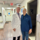 Andrew is taking a picture with Dr. Leone and he is a very happy hip patient