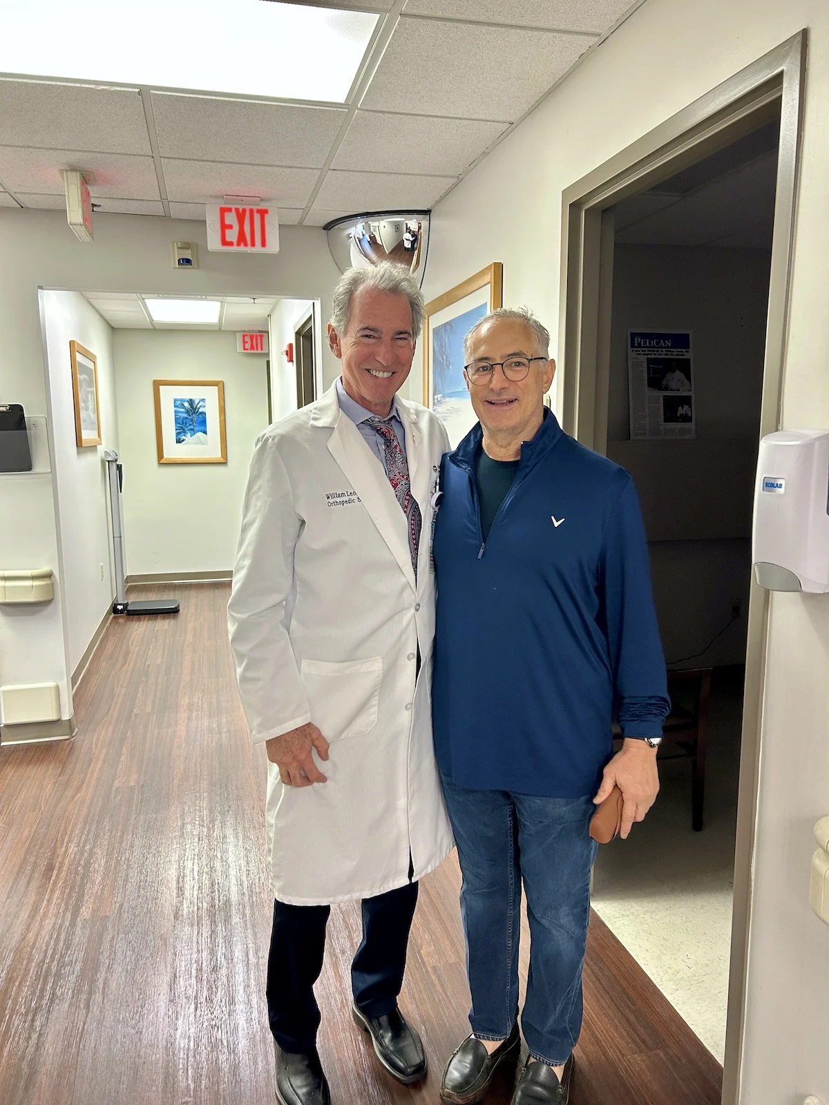 Andrew is taking a picture with Dr. Leone and he is a very happy hip patient
